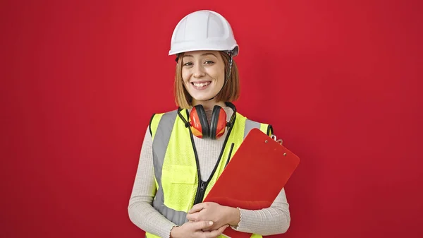 Young Blonde Woman Architect Smiling Confident Holding Clipboard Isolated Red — Stock Photo, Image