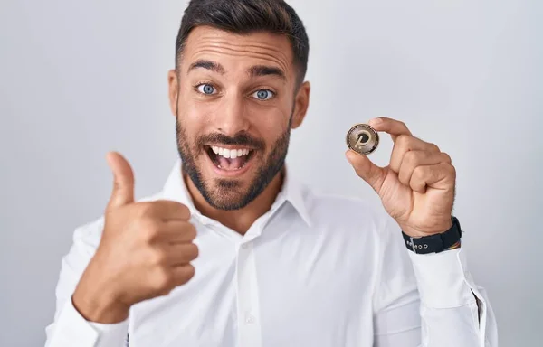 Handsome Hispanic Man Holding Polkadot Cryptocurrency Coin Smiling Happy Positive — Stock Photo, Image