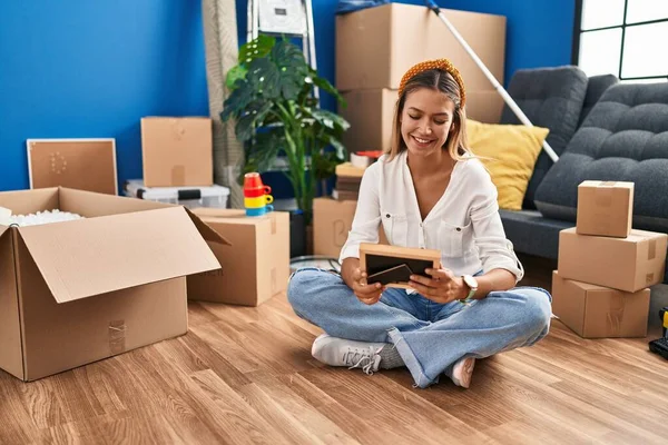 Young Hispanic Woman Looking Photo Sitting Floor New Home — Stock Photo, Image