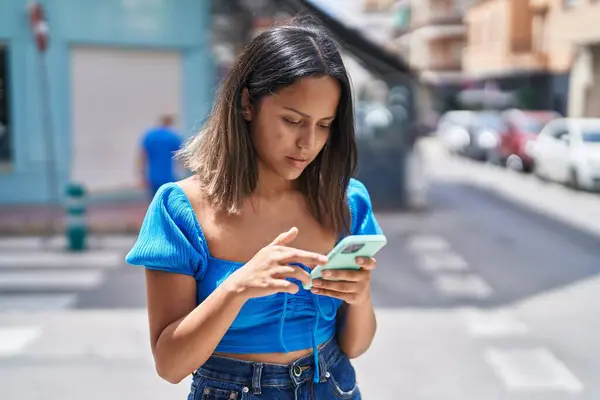 Young Hispanic Woman Using Smartphone Serious Expression Street — Foto de Stock