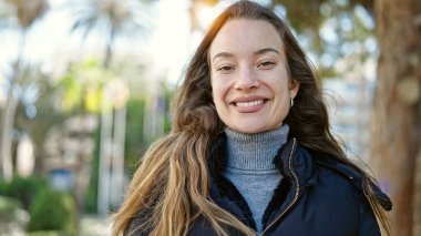 Young caucasian woman smiling confident standing at park