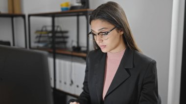 Young beautiful hispanic woman business worker using laptop working at office