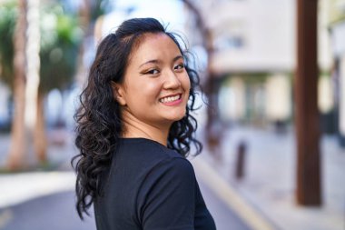 Young chinese woman smiling confident standing at street
