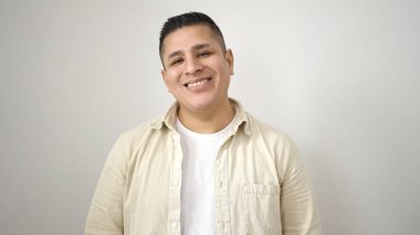 Young hispanic man smiling confident standing over isolated white background