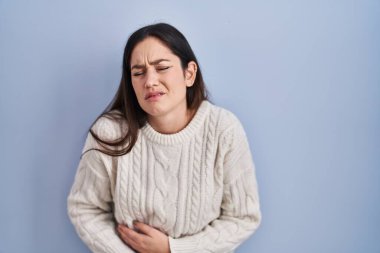 Mavi arka planda, midesi üstünde duran esmer bir kadın. Çünkü hazımsızlık, acı verici bir hastalık, kendini iyi hissetmiyor. Ağrı kavramı. 