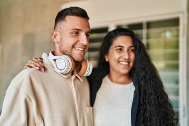 Man and woman couple smiling confident standing together at street