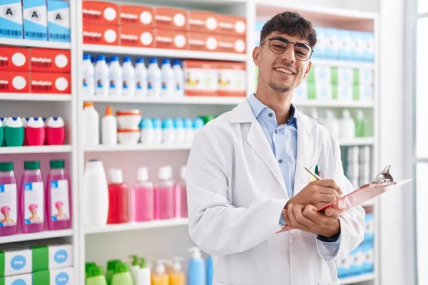 Young Hispanic Man Pharmacist Writing Document Pharmacy — Stock Photo, Image