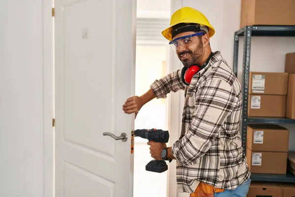 Young Hispanic Man Worker Smiling Confident Repairing Door Home — ストック写真