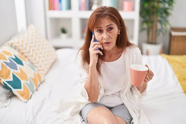 Middle Age Woman Talking Smartphone Drinking Coffee Bedroom — Zdjęcie stockowe