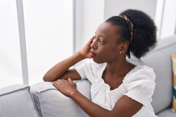 African American Woman Sitting Sofa Serious Expression Home — Stockfoto