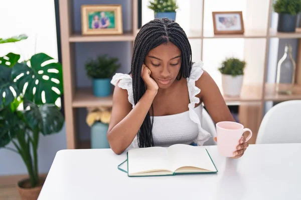 African American Woman Drinking Coffee Reading Book Home — 图库照片