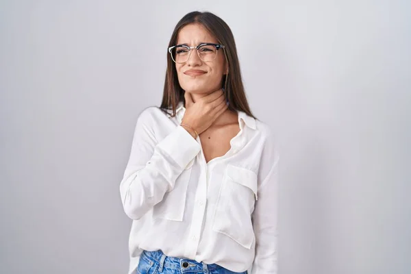 stock image Young brunette woman wearing glasses touching painful neck, sore throat for flu, clod and infection 