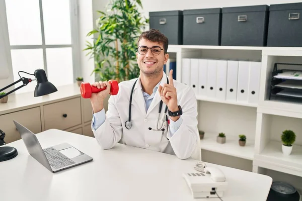 Young Hispanic Doctor Man Holding Dumbbells Surprised Idea Question Pointing — Stock Photo, Image