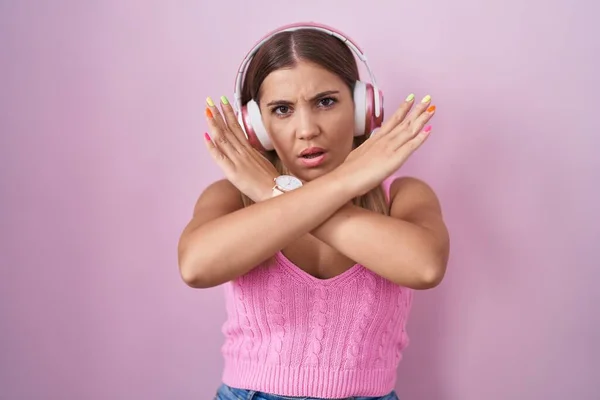 Young Blonde Woman Listening Music Using Headphones Rejection Expression Crossing — Stock Photo, Image