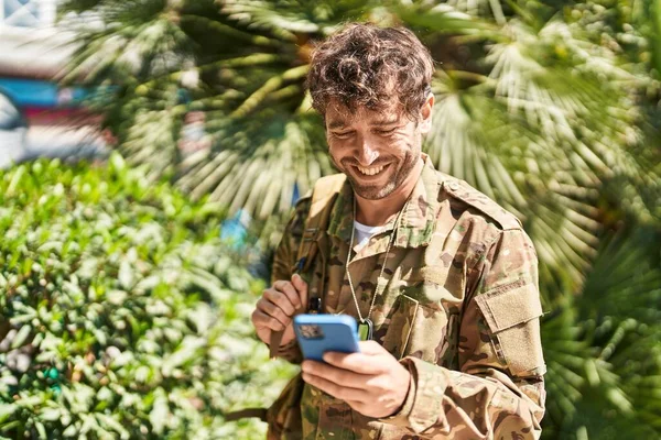 公園でスマートフォンを使用して若い男軍兵士 — ストック写真