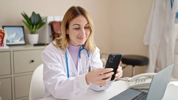 Young Beautiful Hispanic Woman Doctor Using Smartphone Working Clinic — Stockfoto