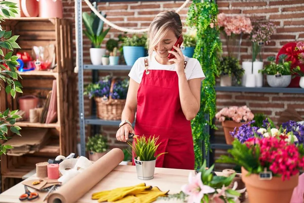 Young Blonde Woman Florist Talking Smartphone Cutting Plant Florist — Stockfoto