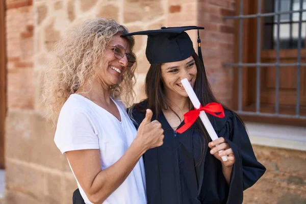 Two Women Mother Graduated Daughter Holding Diploma Doing Gesture Campus — Stok fotoğraf