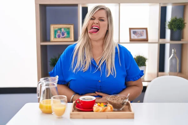 Caucasian Size Woman Eating Breakfast Home Sticking Tongue Out Happy — Stock Photo, Image