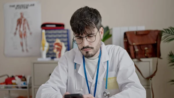Joven Médico Hispano Usando Smartphone Trabajando Clínica —  Fotos de Stock