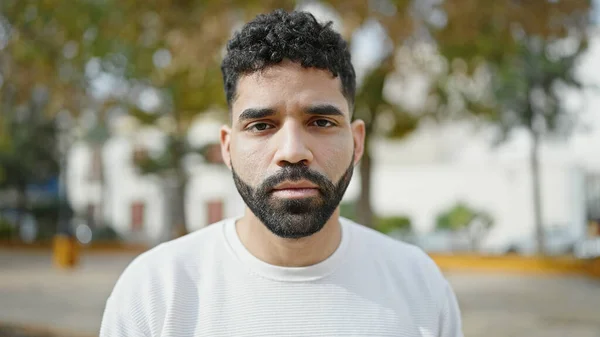Young Hispanic Man Standing Serious Expression Park — Stok fotoğraf