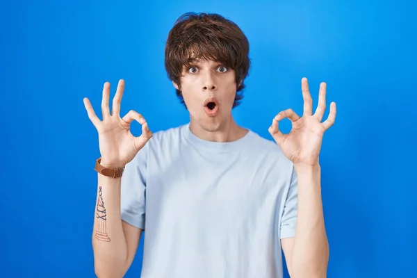 Hispanic Young Man Standing Blue Background Looking Surprised Shocked Doing — Stock Fotó