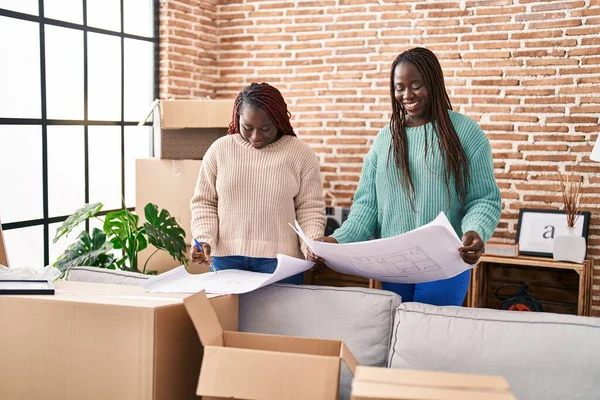 African American Women Smiling Confident Looking House Plans New Home — Fotografia de Stock