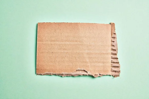 One Ripped Piece Cardboard Material Isolated Green Background — Stock Photo, Image