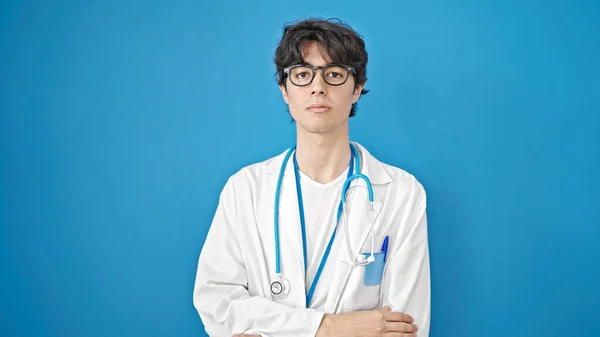 Young Hispanic Man Doctor Standing Serious Expression Isolated Blue Background — Stock Photo, Image