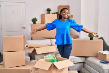 Yeni evinde kendine güvenen Afrikalı Amerikalı kadın gülümsüyor