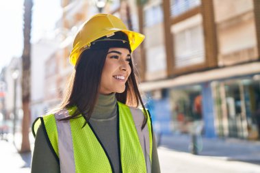 Young beautiful hispanic woman architect smiling confident standing at street