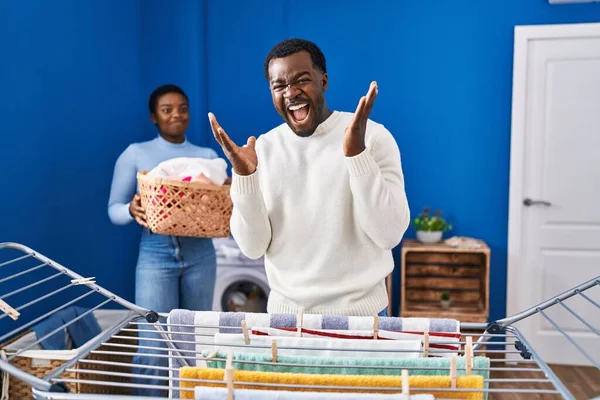 Young African American Couple Hanging Clothes Clothesline Celebrating Victory Happy — Stock Photo, Image
