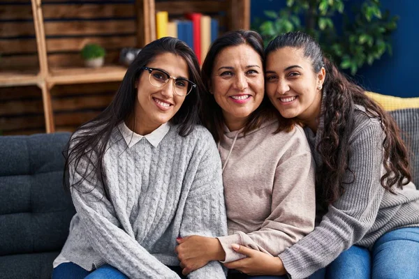 stock image Three woman hugging each other sitting on sofa at home