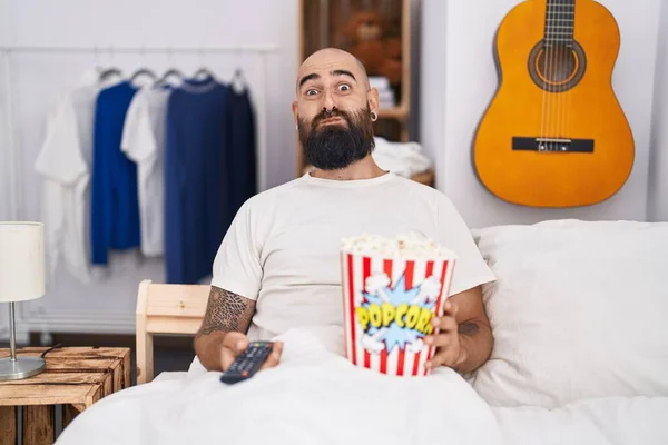 Young Hispanic Man Beard Tattoos Eating Popcorn Bed Puffing Cheeks — Stock Photo, Image