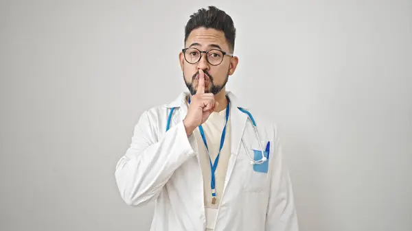 stock image Young latin man doctor asking for silent over isolated white background