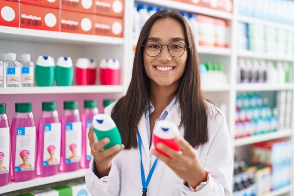 Young Beautiful Hispanic Woman Pharmacist Holding Toothpaste Bottles Pharmacy — 图库照片