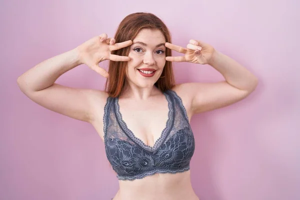 Redhead Woman Wearing Lingerie Pink Background Doing Peace Symbol Fingers — 스톡 사진