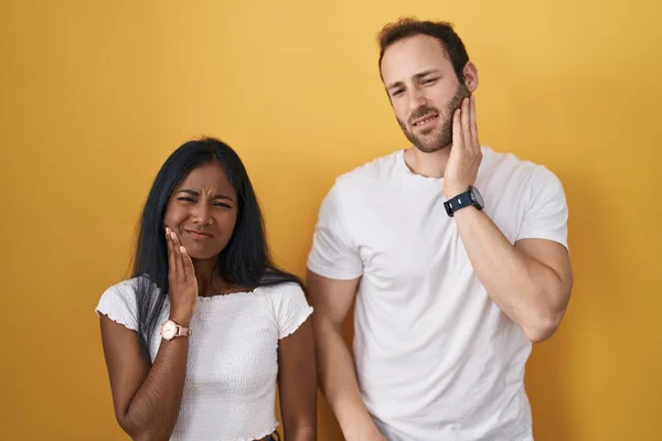 Interracial Couple Standing Yellow Background Touching Mouth Hand Painful Expression — Stock Photo, Image
