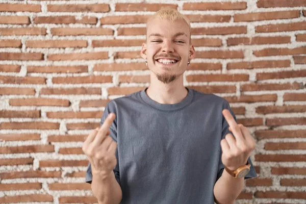 Young Caucasian Man Standing Bricks Wall Showing Middle Finger Doing — Stok fotoğraf