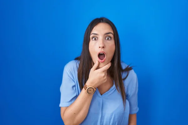 Young Brunette Woman Standing Blue Background Looking Fascinated Disbelief Surprise — Stockfoto