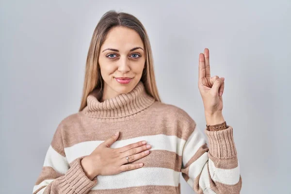 Young Blonde Woman Wearing Turtleneck Sweater Isolated Background Smiling Swearing — Stock Photo, Image