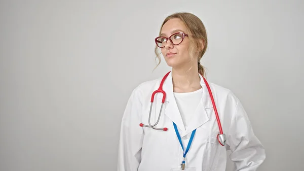 Young Blonde Woman Doctor Looking Side Serious Expression Isolated White — Stock Photo, Image
