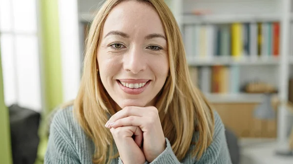 Młoda Blondynka Student Siedzi Stole Uśmiechnięta Uniwersytecie Bibliotece — Zdjęcie stockowe