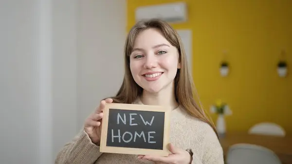 Young Blonde Woman Smiling Confident Holding New Home Blackboard Home — Fotografia de Stock