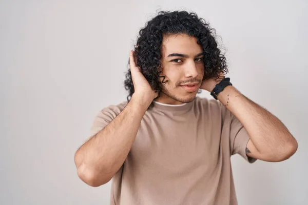 Hispánec Kudrnatými Vlasy Stojící Nad Bílým Pozadím Pokoušející Zaslechnout Obě — Stock fotografie