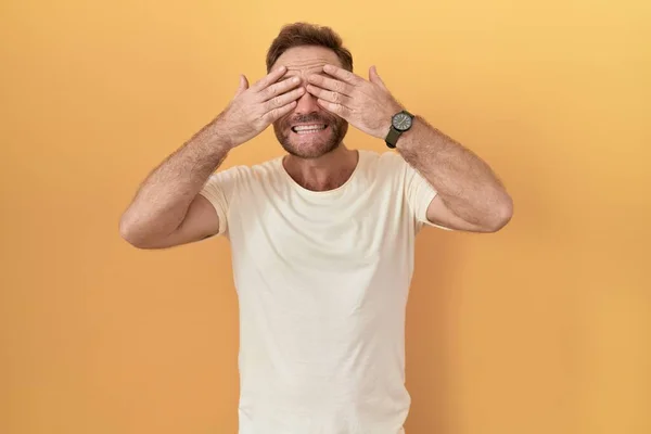 Middle Age Man Beard Standing Yellow Background Covering Eyes Hands — Stock Photo, Image