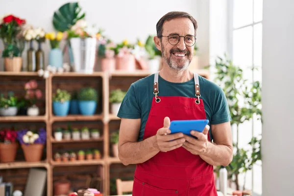 stock image Middle age man florist smiling confident using touchpad at florist