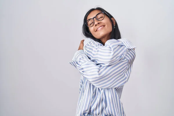 Young Hispanic Woman Wearing Glasses Hugging Oneself Happy Positive Smiling — Stock Photo, Image