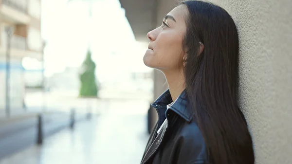 stock image Young beautiful hispanic woman looking to the side with serious expression at street