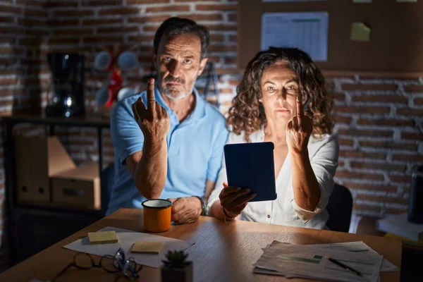 Middle Age Hispanic Couple Using Touchpad Sitting Table Night Showing — Foto Stock